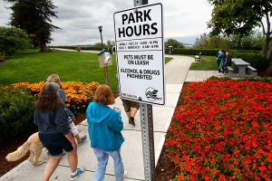 Dog walkers at Everett&rsquo;s Grand Avenue Park were greeted Monday by a new sign spelling out hours: 6 a.m.-10 p.m. April through October and 6 a.m.-8 p.m. November through March. (Dan Bates / The Herald)