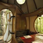 In Vancouver Island&rsquo;s rain forest, visitors can book sphere rooms in a treehouse hotel. Shown is the Eryn sphere&rsquo;s interior with views of the forest through the doorway, skylight, and table-side window. (Photo by Adam Clarke)