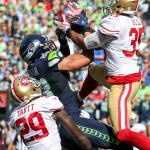 Seahawks tight end Jimmy Graham muscles in a reception with 49ers safety Jaquiski Tartt, left, and 49ers safety Eric Reid defending Sunday afternoon at Century Link Field in Seattle on September 25, 2016. The Seahawks are 2-1 after defeating the 49ers 37-18. (Kevin Clark / The Herald)
