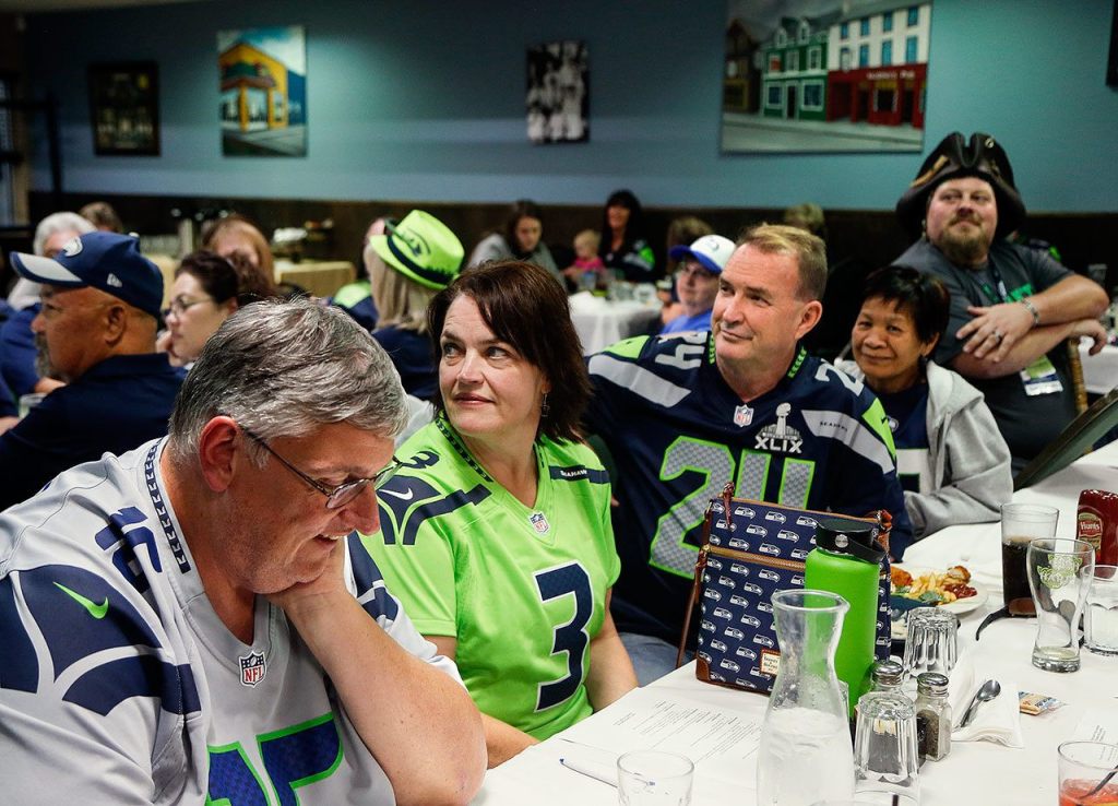 Lori Hammond (center #3) was the only club member wearing the new Action Green jersy at Tuesday night&rsquo;s Snohomish County Sea Hawkers Booster Club meeting and dinner at Shawn O&rsquo;Donnell&rsquo;s. (Dan Bates / The Herald)