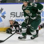 Everett&rsquo;s Riley Sutter controls the puck with the Giants&rsquo; Dawson Holt trailing during a game Saturday at Xfinity Arena in Everett. (Kevin Clark / The Herald)