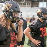 Monroe&rsquo;s JJ Jerome (left) and Zach Zimmerman look to the coaches for a play during practice Thursday afternoon at Monroe High School. (Kevin Clark / The Herald)