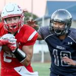 Snohomish&rsquo;s Josh Johnston runs for additional yards after a reception with Glacier Peak&rsquo;s Sean Bad trailing Friday night at Veterans Memorial Stadium in Snohomish. (Kevin Clark / The Herald)