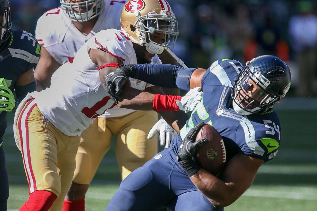 49ers wide receiver Quinton Patton attempts to tackle Seahawks linebacker Bobby Wagner after an interception Sunday afternoon at Century Link Field in Seattle on September 25, 2016. The Seahawks are 2-1 after defeating the 49ers 37-18. (Kevin Clark / The Herald)