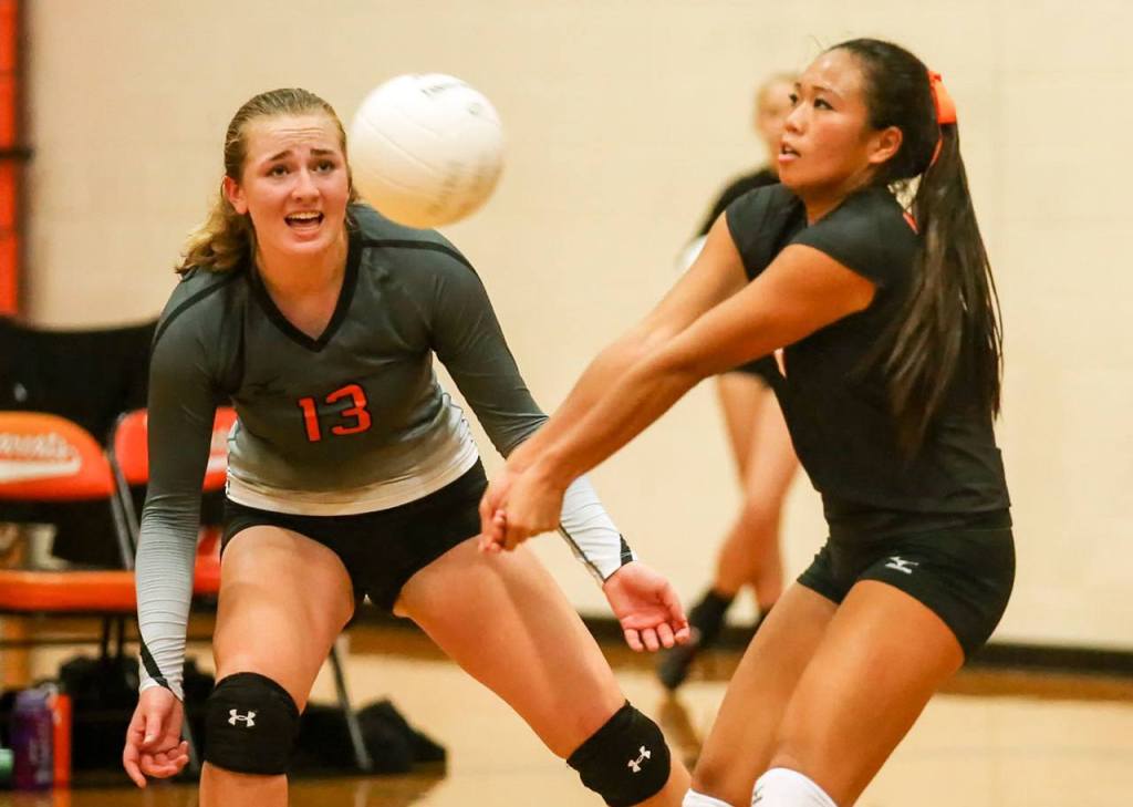 Monroe&rsquo;s Mina Duong makes dig as Samantha Zimmerman (left) looks on Wednesday night in the Bearcats&rsquo; 3-1 win over Jackson at Monroe H.S. (Kevin Clark / The Herald)