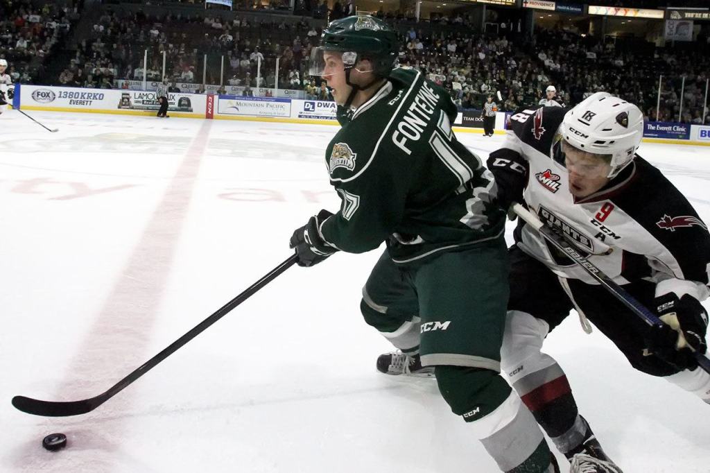 Everett&rsquo;s Matt Fonteyne controls the puck with Giants Jack Flaman trailing in the first period during the season opener at Xfinity Arena in Everett on September 24, 2016. (Kevin Clark / The Herald)