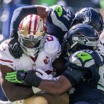 Kevin Clark / The Herald                                49ers running back Carlos Hyde is tackled by Seahawks linebackers Bobby Wagner (top) and K.J. Wright during Sunday&rsquo;s game at CenturyLink Field.