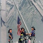 Brooklyn firefighters raise a flag at the site of the World Trade Center in New York on Sept. 11, 2001. The flag is believed to have turned up in 2014 in Everett under mysterious circumstances. (Thomas E. Franklin / The Record of Bergen County, New Jersey, via AP)