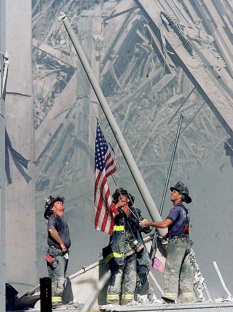 Brooklyn firefighters raise a flag at the site of the World Trade Center in New York on Sept. 11, 2001. The flag is believed to have turned up in 2014 in Everett under mysterious circumstances. (Thomas E. Franklin / The Record of Bergen County, New Jersey, via AP)