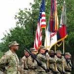 Col. Reginald Neal, far left, commander of the 48th Infantry Brigade of the Georgia National Guard, stands with an Army color guard Friday during a ceremony at Fort Stewart, Georgoa, to mark the brigade&rsquo;s new alignment with the Army&rsquo;s 3rd Infantry Division. The Army is pairing a dozen National Guard and Reserve units nationwide with active-duty commands, hoping to improve the combat readiness of citizen-soldiers. (AP Photo/Russ Bynum)