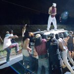 Protesters surround a police vehicle in Charlotte, North Carolina, on Tuesday. Authorities used tear gas to disperse protesters in an overnight demonstration that broke out after Keith Lamont Scott was fatally shot by an officer at an apartment complex. (Jeff Siner/The Charlotte Observer via AP)
