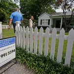 A real estate agent, right, prepares to show a home for sale in Mount Pleasant, South Carolina, in April. (AP Photo/Chuck Burton)