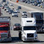 In this Aug. 24 photo, truck and automobile traffic mix on I-5, headed north through Fife, near the Port of Tacoma. Truckers are warning that a government plan to electronically limit the speed of tractor-trailer rigs will lead to highway traffic jams and even an increase in deadly run-ins with cars allowed to travel at faster speeds. (AP Photo/Ted S. Warren, File)