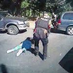 This image made from video shows Keith Scott on the ground as police approach him in Charlotte, North Carolina, on Sept. 20. (Charlotte-Mecklenburg Police Department via AP)