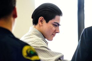 (Dan Bates / The Herald) Chris Gonzalez-Garcia is handed over to his defense attorney Paul Thompson at the start of his trial, Thursday. He is accused of strangling to death Chris Davis, whom he contacted through an ad on Facebook last year.
