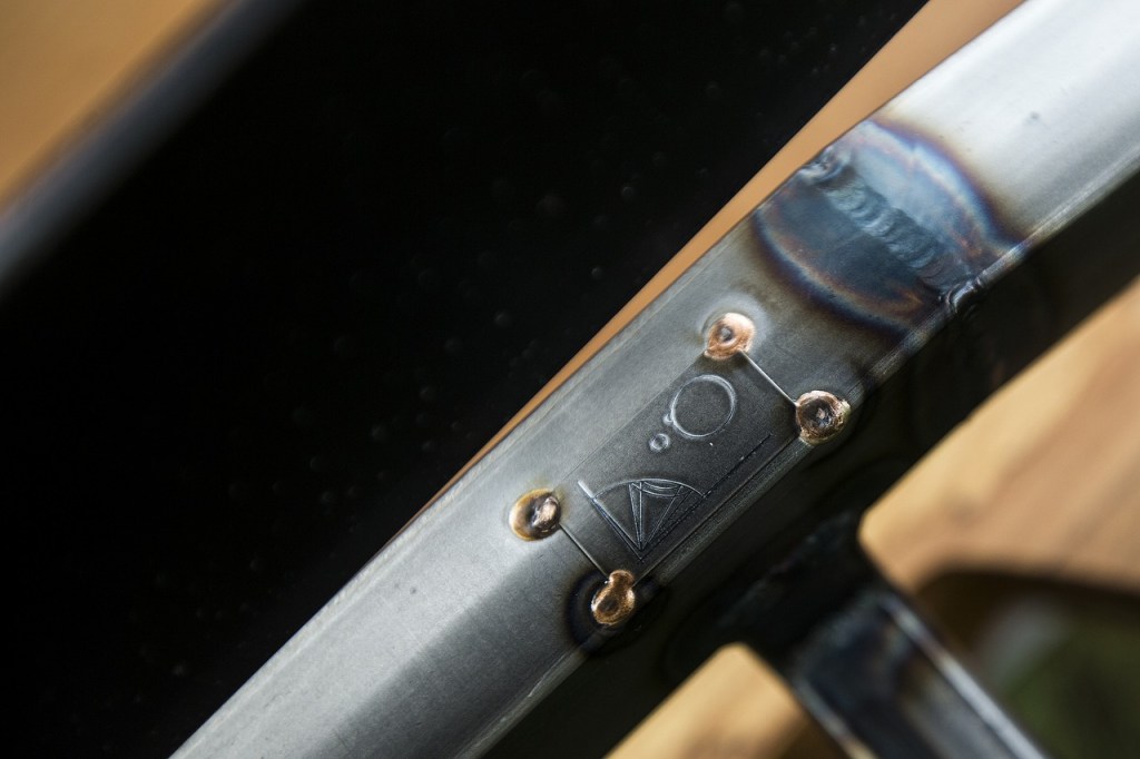 Artist Sean Carleton&rsquo;s signature is emblazoned on a bench at his studio in Bothell. (Ian Terry / The Herald)