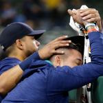 The Mariners&rsquo; Franklin Gutierrez (left) consoles pitcher Felix Hernandez (right) after the Athletics defeated the Mariners 9-8 in 10 innings Saturday in Seattle. (AP Photo/Ted S. Warren)