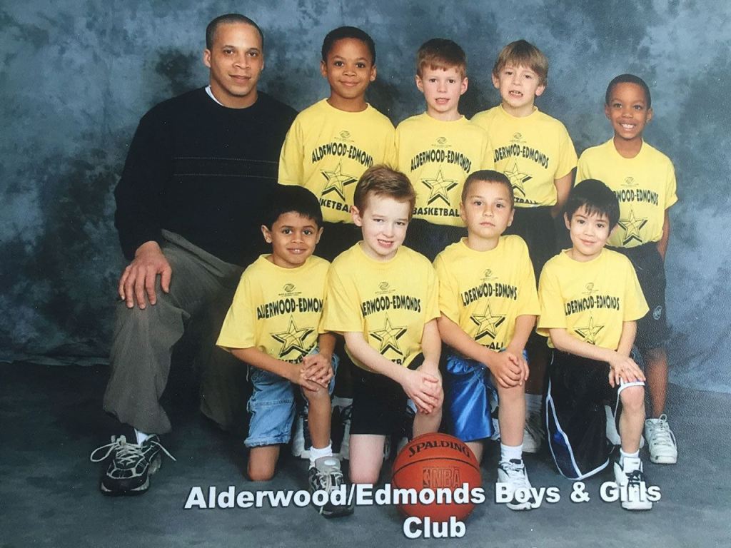 Scott Gaskin (far left) is shown as the coach of the Alderwood/Edmonds Boys and Girls Club basketball team, which included his son, University of Washington running back Myles Gaskin (top row, second from left). (Gaskin family photo)