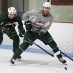 Silvertips defenseman Mackenzie Dwyer (right) fends off center Brian King during a team practice at the Lynnwood Ice Center on Tuesday, Sept. 27. (Ian Terry / The Herald)