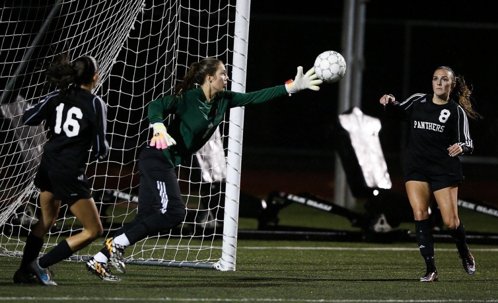 Marysville-Getchell goalkeeper Carley Wika (center) reaches out to grab a loose ball as Snohomish&rsquo;s Taylor Khorrami (16) and Anna Montemor (8) look on during a game at Marysville-Getchell High School on Tuesday, Oct. 4. (Ian Terry / The Herald)