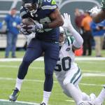 Seahawks running back C.J. Spiller catches a pass for a touchdown in front of the Jets&rsquo; Darron Lee (50) during the first half of a game Sunday in East Rutherford, N.J. (AP Photo/Bill Kostroun)