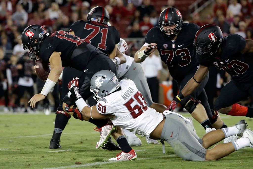 Stanford quarterback Ryan Burns (top left) is sacked by Washington State defensive lineman Hercules Mata&rsquo;afa during the second half of a game Saturday in Stanford, Calif. (AP Photo/Marcio Jose Sanchez)