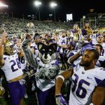 Washington players celebrate their 70-21 win over Oregon on Saturday in Eugene, Ore. (AP Photo/Thomas Boyd)
