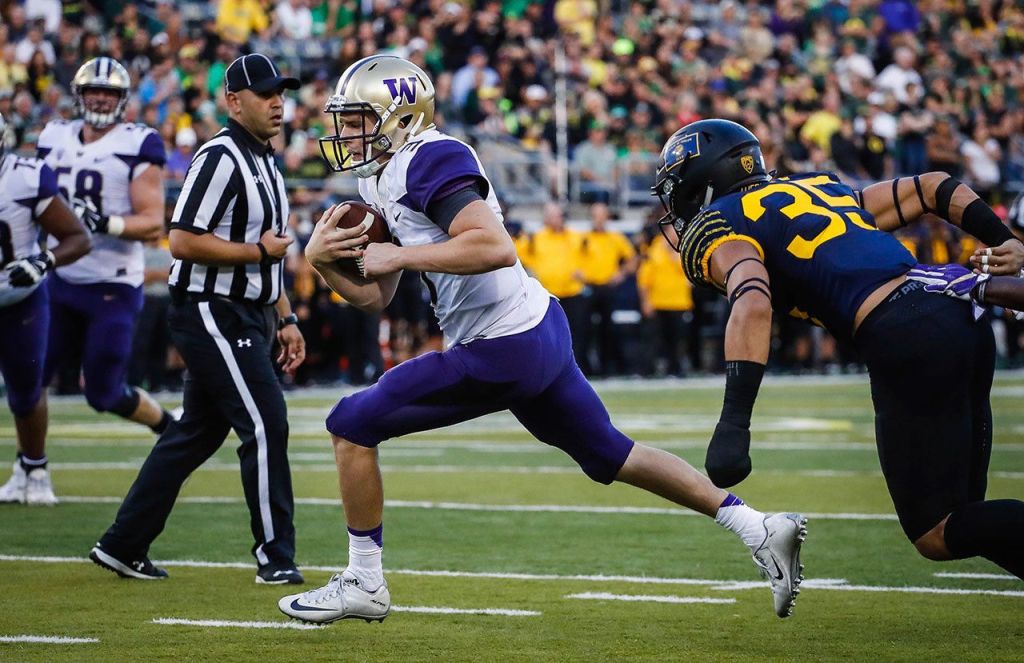 Washington quarterback Jake Browning (3) scores on the last drive of the first half against Oregon on Saturday in Eugene, Ore. (AP Photo/Thomas Boyd)