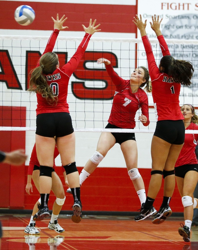 Stanwood&rsquo;s Taya Shoemaker (7) spikes the ball between Mountlake Terrace&rsquo;s Leeann Weatherby (10) and Emilie Roldan (1) during a game at Stanwood High School on Tuesday, Oct. 11. (Ian Terry / The Herald)