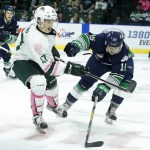 Silvertips center Brett Kemp (47) battles for a loose puck with Thunderbirds right wing Layne Bensmiller (15) during a game Saturday at Xfinity Arena in Everett. (Ian Terry / The Herald)