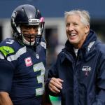 Seahawks quarterback Russell Wilson (left) talks with head coach Pete Carroll before a game against the Falcons this past Sunday in Seattle. (AP Photo/Elaine Thompson)