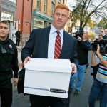 Former Penn State assistant football coach Mike McQueary (center) leaves the Centre County Courthouse Annex in Bellefonte, Pa. on Monday, Oct. 17, 2016, after the first day of his defamation and whistleblower lawsuit. (AP Photo/Gene J. Puskar)