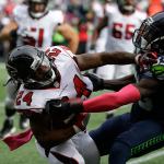 Seahawks strong safety Kelcie McCray (33) tackles Falcons running back Devonta Freeman (24) in the first half of a game Oct. 16 in Seattle. (AP Photo/Elaine Thompson)