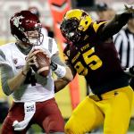 Washington State quarterback Luke Falk (4) looks to throw under pressure from Arizona State defensive lineman Renell Wren (95) during the first half of a game Saturday in Tempe, Ariz. (AP Photo/Matt York)