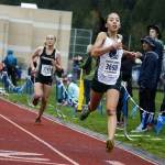 Edmonds-Woodway&rsquo;s Yukino Parle (right) crosses the line to win the girls 3A District 1 cross country meet at South Whidbey High School on Saturday. Parle fell late in the race, but got up and still claimedvictory on the muddy and hilly course on Whidbey Island. (Ian Terry / The Herald)
