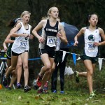 Edmonds-Woodway&rsquo;s Yukino Parle (right) and Lynnwood&rsquo;s Malia Pivec (center) race to first and second place, respectively, at the girls 3A District 1 cross country meet at South Whidbey High School on Saturday. (Ian Terry / The Herald)