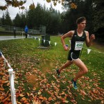Jackson&rsquo;s Matthew Watkins runs through autumn leaves on his way to winning the boys 4A District 1 cross country meet at South Whidbey High School on Saturday. (Ian Terry / The Herald)