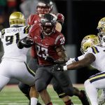 Washington State running back Gerard Wicks (23) runs with the ball in front of UCLA linebacker Jayon Brown (12) during the second half of a game against UCLA on Oct. 15 in Pullman. (AP Photo/Young Kwak)