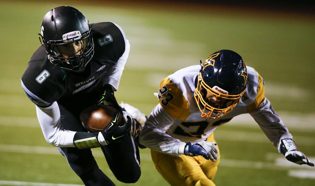 Jackson&rsquo;s Daniel Arias (6) hauls in a catch for a touchdown in the first quarter as Mariner&rsquo;s Tyrone Jones (23) defends during a game Friday at Everett Memorial Stadium. (Ian Terry / The Herald)