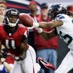 Seattle cornerback Richard Sherman defends against Atlanta wide receiver Julio Jones during an NFC playoff game in January of 2013. (AP Photo/Dave Martin, File)