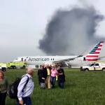 Passengers walk away from a burning American Airlines Boeing 767 that aborted takeoff and caught fire on the runway at Chicago&rsquo;s O&rsquo;Hare International Airport on Friday. (Jose Castillo)