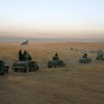A convoy drives toward a frontline in Khazer, about 19 miles east of Mosul, Iraq, on Monday. The Iraqi military and the country&rsquo;s Kurdish forces say they launched operations to the south and east of militant-held Mosul early Monday morning. (AP Photo/Bram Janssen)
