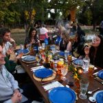 Diners smoke marijuana as they eat dishes prepared by chefs during an evening of pairings of fine food and craft marijuana strains served to invited guests dining this month at Planet Bluegrass, an outdoor venue in Lyons, Colorado. (AP Photo/Brennan Linsley)