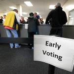 Local residents receive their ballots at the Polk County Election Office on the first day of early voting in Des Moines, Iowa, on Thursday. (AP Photo/Charlie Neibergall)