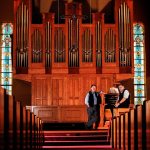 At Everett&rsquo;s First Presbyterian Church on Monday, church organist Gary Norris (right) talks with John Moir, of Balcom and Vaughan Pipe Organs. Moir designed the nearly two-story-high organ, which contains more than 2,000 pipes. (Dan Bates / The Herald)