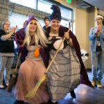 Everett Community College&rsquo;s Elise Mayes (left) and Stacy Siler creep around as they accept their Faculty and Staff second-place win as the Sanderson Sisters, from the movie &ldquo;Hocus Pocus,&rdquo; during the Hallo-Scream Contest at Everett Community College on Monday, Oct. 31, in Everett. (Andy Bronson / The Herald)