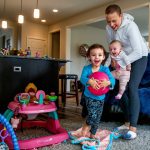 Carrying 4-month-old Haven, Apryl Roberts chases 2-year old Charlee around the house Wednesday, to the delight of all three. (Dan Bates / The Herald)