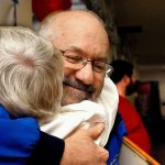 Frank Fargo, who offers free showers out of his trailer, is among 2016 KSER Voice of the Community Award winners. He is shown here in 2012 getting a hug from Lois Sugars at Everett&rsquo;s First Presbyterian Church, where he provides showers during a weekly dinner for people who are homeless. (Sarah Weiser / The Herald)