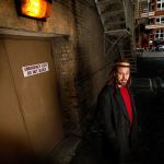 Musician Jason Webley looks around a gritty slice of old-Everett in the alley outside the Historic Everett Theatre, where he and other singer-songwriters will perform a concert Nov. 4 based on the Everett Massacre. The show, &ldquo;100 Years Ago Tomorrow,&rdquo; will feature original songs related to the labor strife that exploded in a gunfight on Everett&rsquo;s waterfront Nov. 5, 1916. (Dan Bates / The Herald)