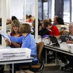 Workers inspect, count and organize ballots coming in from Snohomish County mail-in voters at an office across from the Future of Flight museum in Mukilteo on Thursday. The county has almost 250 people employed to handle all aspects of counting this year&rsquo;s ballots. (Ian Terry / The Herald)
